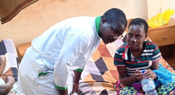 Our head nurse listening to patient in the ward